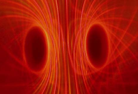 Red ferrocell field image with two dark oval centers and bright converging curves between them.