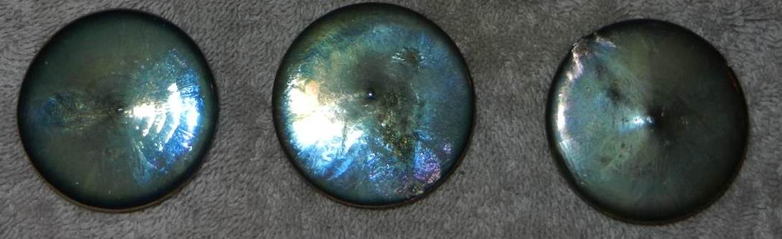 Below: Bismuth disk pours which always end their cooling cycle in maintaining their dielectric inertia by raising a small bump in the center, ever-resisting solidification and seeking counterspatial formations. Likewise 