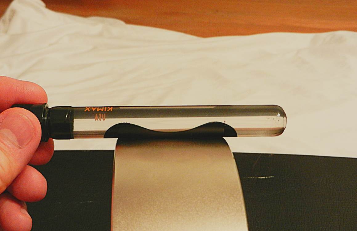 BELOW: Typical ferrofluid resting against the dielectric inertial plane of a very large 6” by 2” neodymium “magnet”. This position causes divergence of the nano-iron particles away from the dielectric dominant inertial p