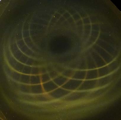 Below: Notice distorted pole on image both left and right as created by image in center of a ½ cylinder magnet stuck in the center of a much larger ceramic ring magnet. All field pressures mediate themselves as necessita