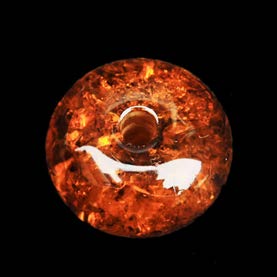 Below: Ancient Viking amber whorl, which when spun in creating thread, would cause an electrostatic charge to form.