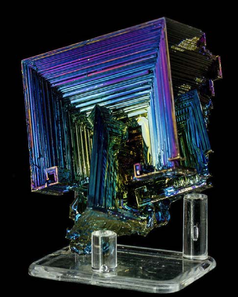 Below: A perfect example of a bismuth anti-cube, or hypercube, with a smaller cube intersecting the larger during formation wherein which dielectric inertia forms these centripetal “hopper crystal” formations.
