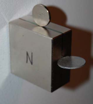 Below: Left is a 5/8” neodymium with a disk magnet in parallel to the 5/8” dielectric inertial plane, also a steel ring sitting perpendicular to the dielectric inertial plane. Middle picture, steel disk perpendicular to 