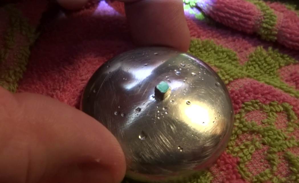 Below: Single 3mm neodymium cube “magnet” and pure bismuth disk (highest diamagnetic element), one pole marked green, and the other black. When pushed or tilted off the bismuth, the one polarity will always spin off CW, 
