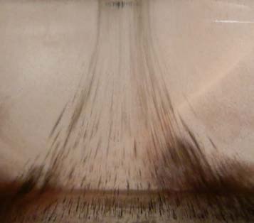 Below: One of my ferrofluid inventions/ suspensions with one of the poles above causing dielectric coherency in the ferrous particles and resultant acceleration to the pole-face. This is dielectric induction coherency. W