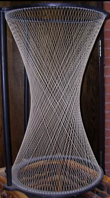 Hourglass-shaped string hyperboloid stretched between two circular frames.