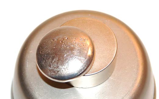 Below: Bismuth disk’s final resting place, perpetually ending at the same spread leaving the same golden ratio attraction (voidance) and countervoidance (repulsion) position along the 2”x1” cylinder neodymium. This harmo