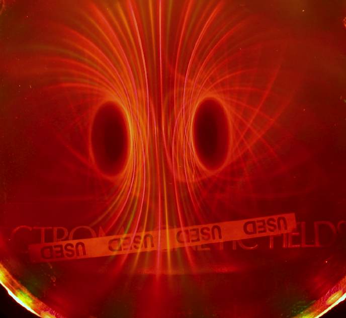 Below: [Photo courtesy of Michael Snyder of revolution-labs.com] Notice the color displacements, the green and yellow exist only along the dielectric inertial plane of the magnet, whereas the poles are illustrated (as th
