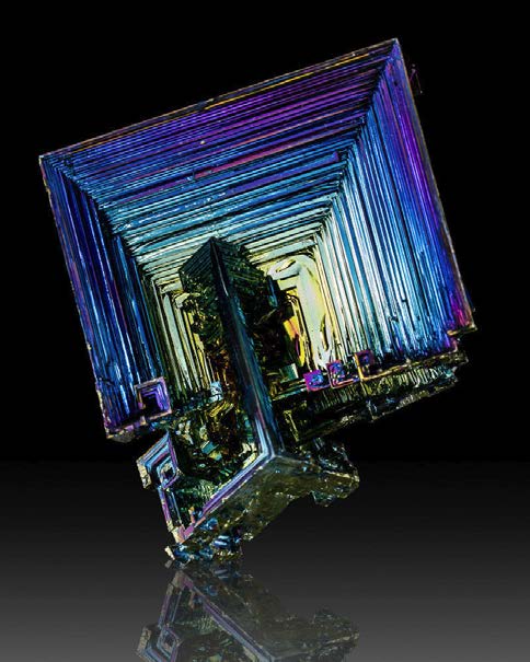 Below: A perfect example of a bismuth anti-cube, or hypercube, with a smaller cube intersecting the larger during formation wherein which dielectric inertia forms these centripetal “hopper crystal” formations.