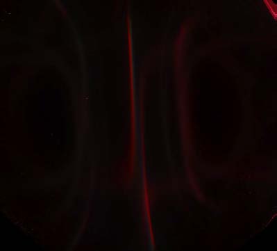 Below: On left very low light levels showing all light being brought along the dielectric inertial plane; both poles are left and right in the image. On right is blue light concentrated along the dielectric inertial plan