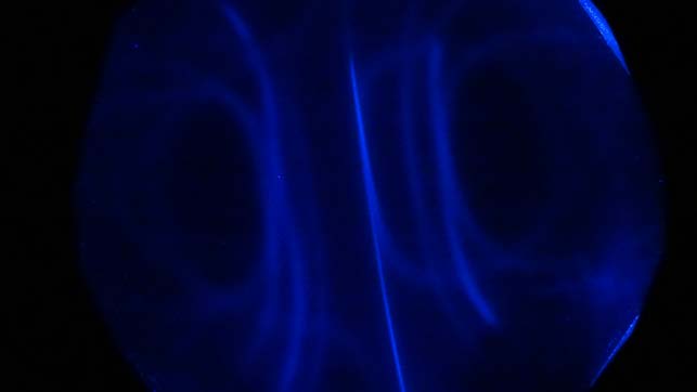 Below: On left very low light levels showing all light being brought along the dielectric inertial plane; both poles are left and right in the image. On right is blue light concentrated along the dielectric inertial plan
