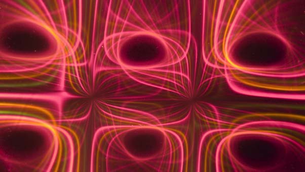 Below: [Photo courtesy of Michael Snyder of revolution-labs.com]. On the left are 3 magnets, some undergoing voidance, and the far left and right undergoing counter-voidance (repulsion). On the right is light being direc
