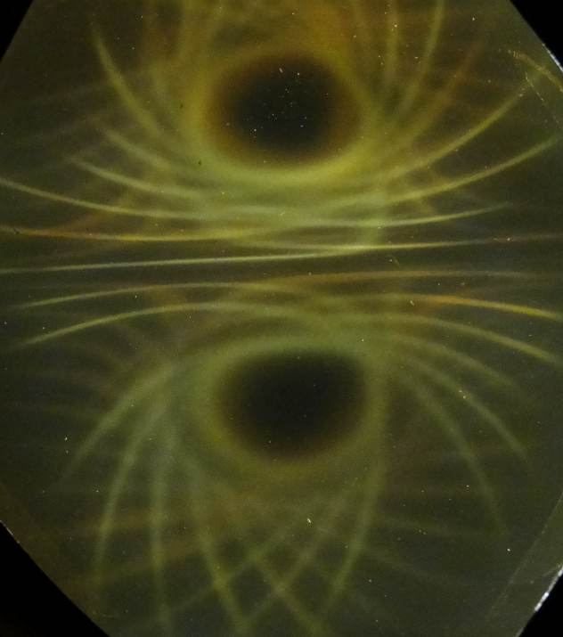 Below: Large ceramic ring magnet on left showing the pair of hypotrochoids. Notice the depth of holographic effect as seen in the sphere on the left at the center of the ring magnet. Closing dielectric voidances are nece