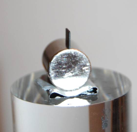 Below: Pyrolytic graphite easily balanced along its edge in line with the divergent centrifugal magnetism to which the diamagnetic pyrolytic graphite is repulsed due to high order dielectric inertia within the carbon cry