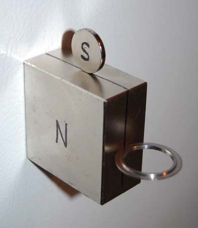 Below: 2x2x1” block neodymium, sitting on top is a disk magnet, on the side is a steel disk, sitting perpendicular to the dielectric inertial plane, bottom is a steel ring with a knife-thin edge also sitting perpendicula